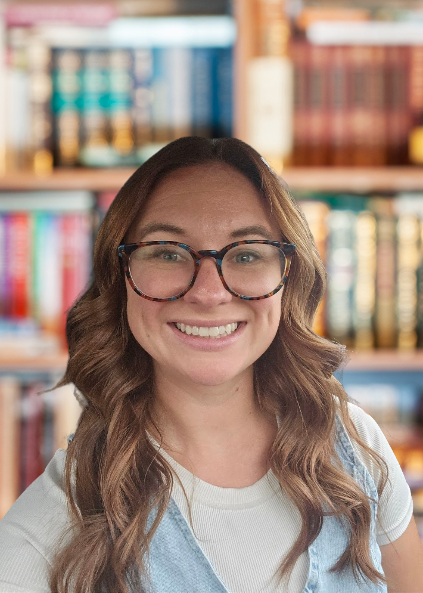 Brittany Summerhays smiling in front of classroom bookshelf